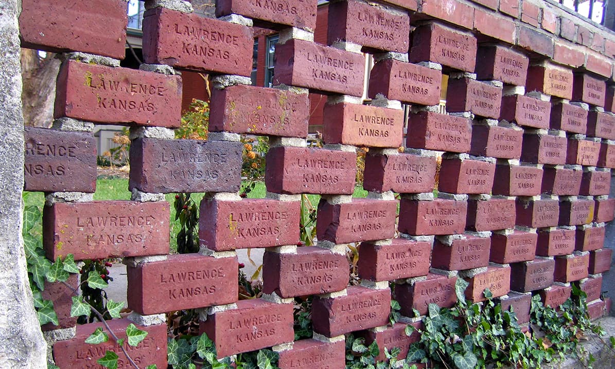 Historic paving bricks each stamped 'Lawrence, Kansas', the city's signature brick streets